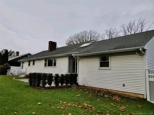 a front view of a house with a garden and yard