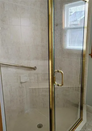 a bathroom with a glass shower door