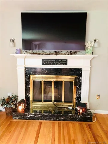 a view of fireplace and wooden floor