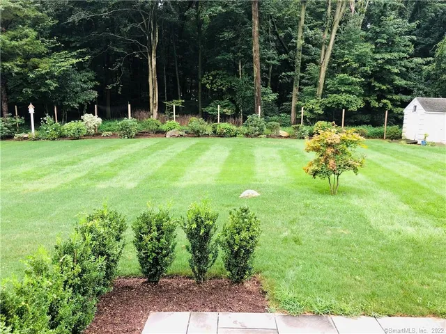 a backyard of a house with table and chairs