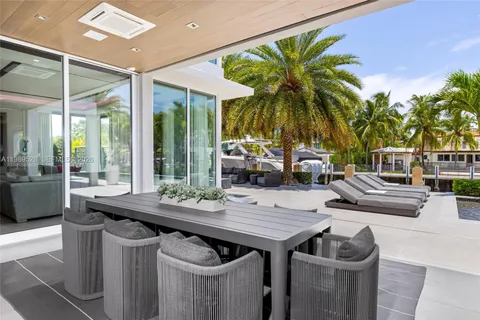a bedroom with a bed lamp and a large window