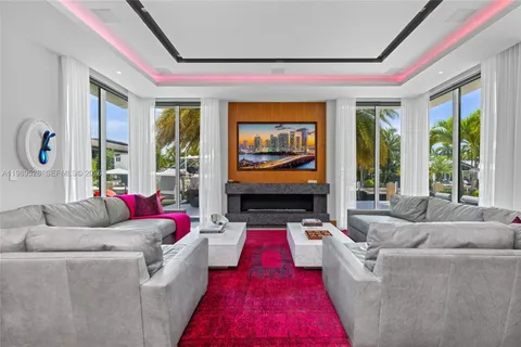 a living room with furniture a rug and kitchen view