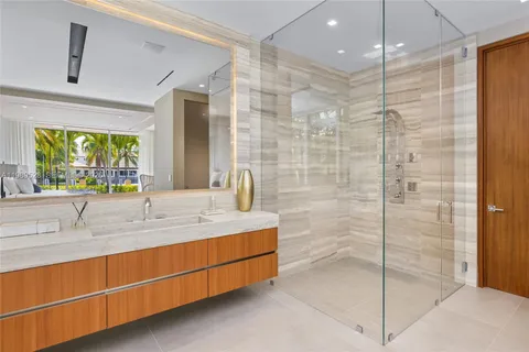 a bathroom with a double vanity sink toilet and a tub