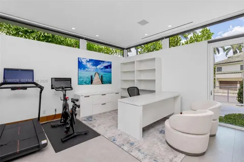 a kitchen with stainless steel appliances kitchen island granite countertop a dining table chairs sink and cabinets
