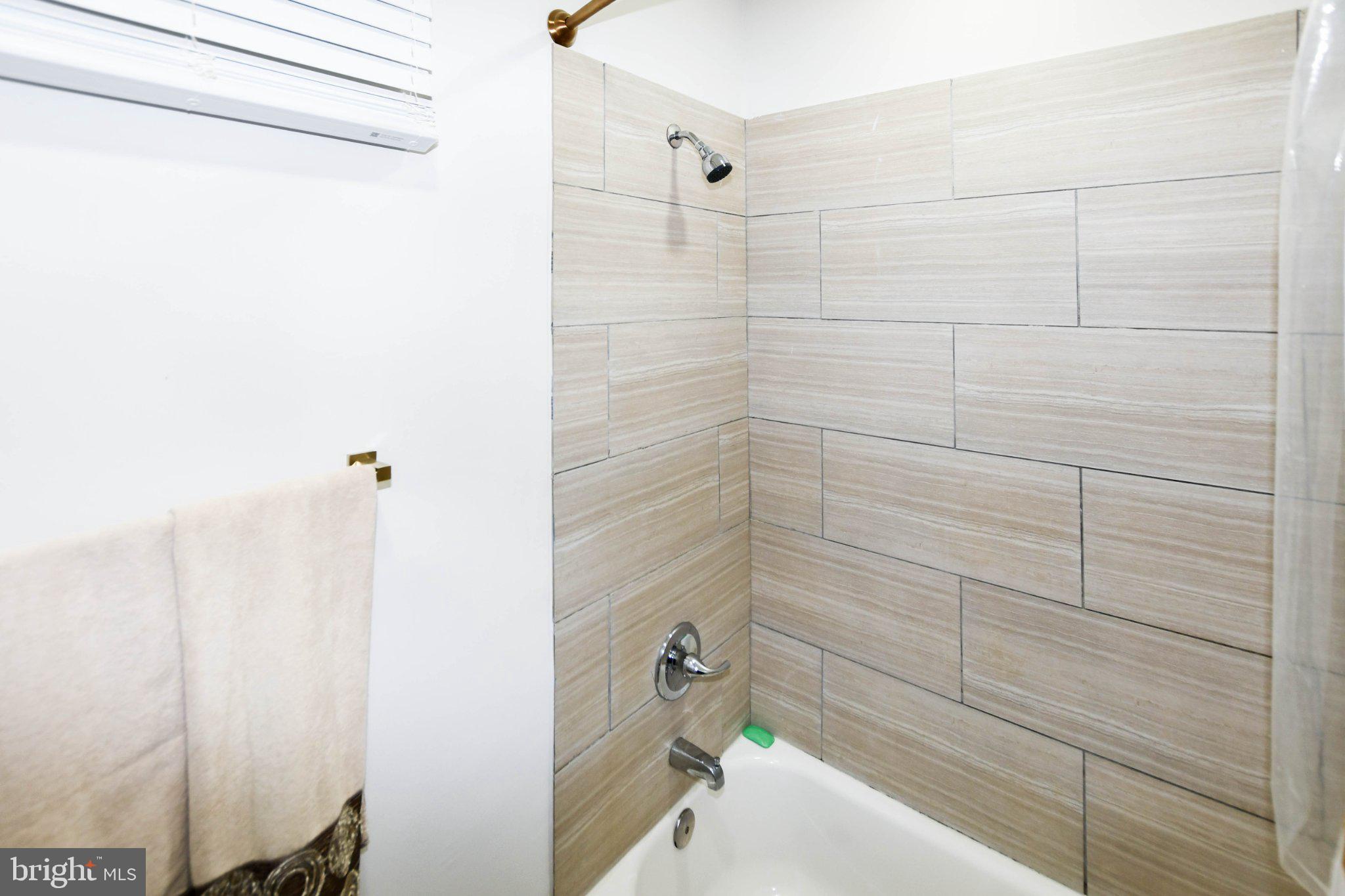 554 Newcomb Street Southeast, Unit 4 Washington, DC 20032 - Photo 9 of 20 Modern shower with sleek tile design.