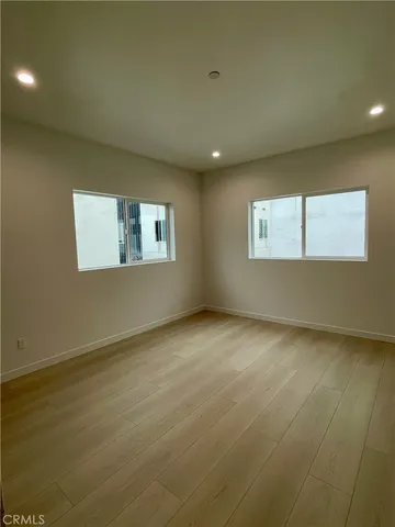 an empty room with a empty space and windows