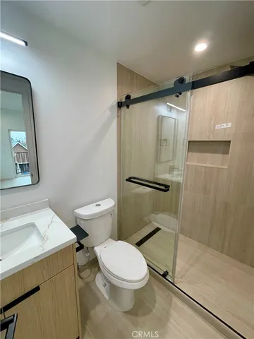 a white toilet sitting next to a bath tub