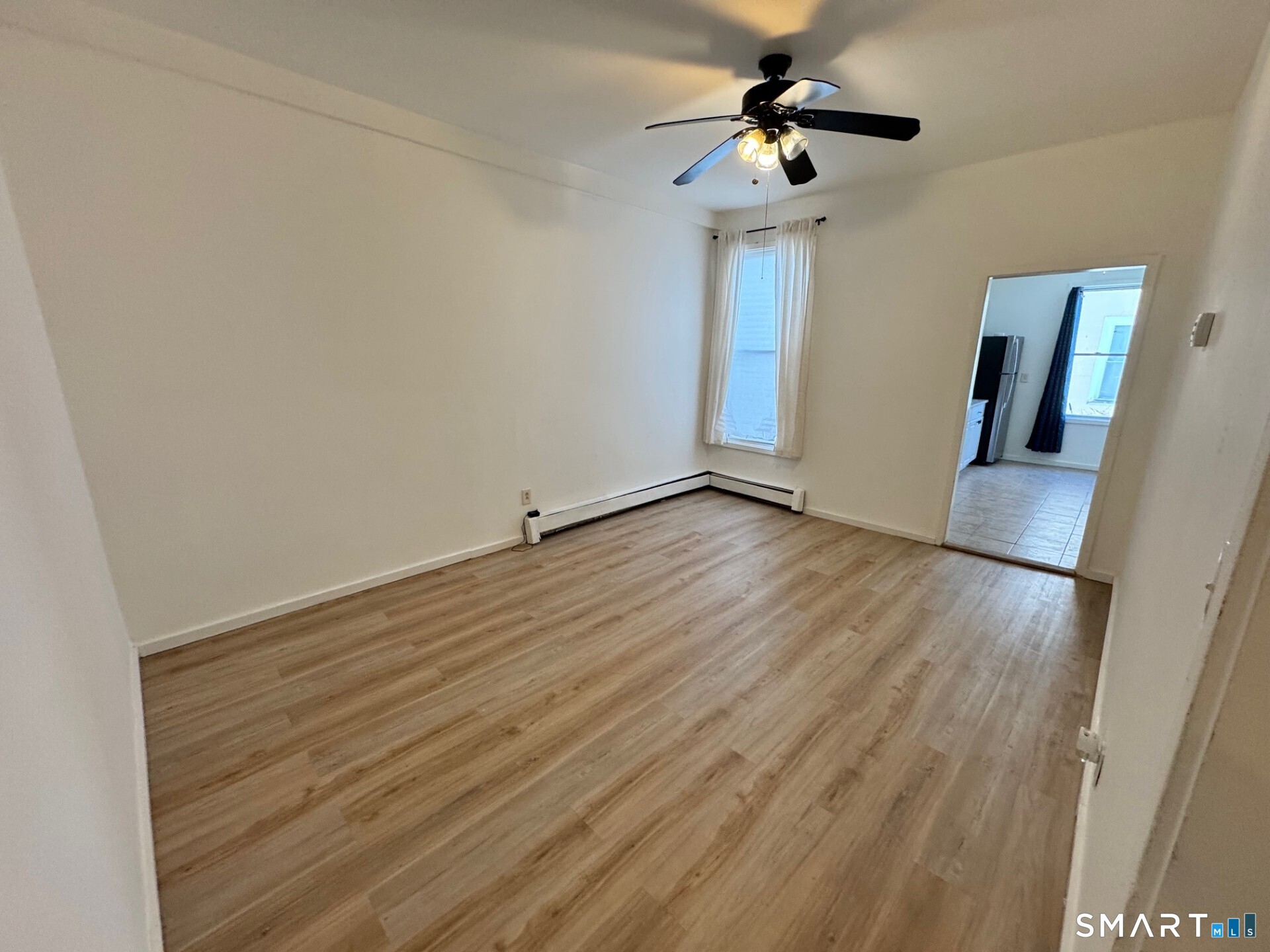1 Seeley Street, Unit 2 Bridgeport, CT 06605 - Photo 2 of 8 a view of room with wooden floor and ceiling fan