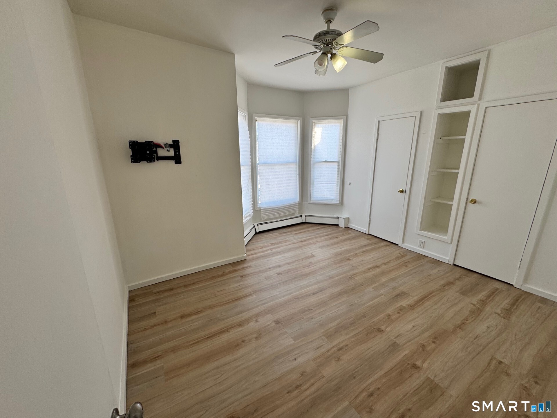 1 Seeley Street, Unit 2 Bridgeport, CT 06605 - Photo 3 of 8 an empty room with wooden floor and ceiling fan