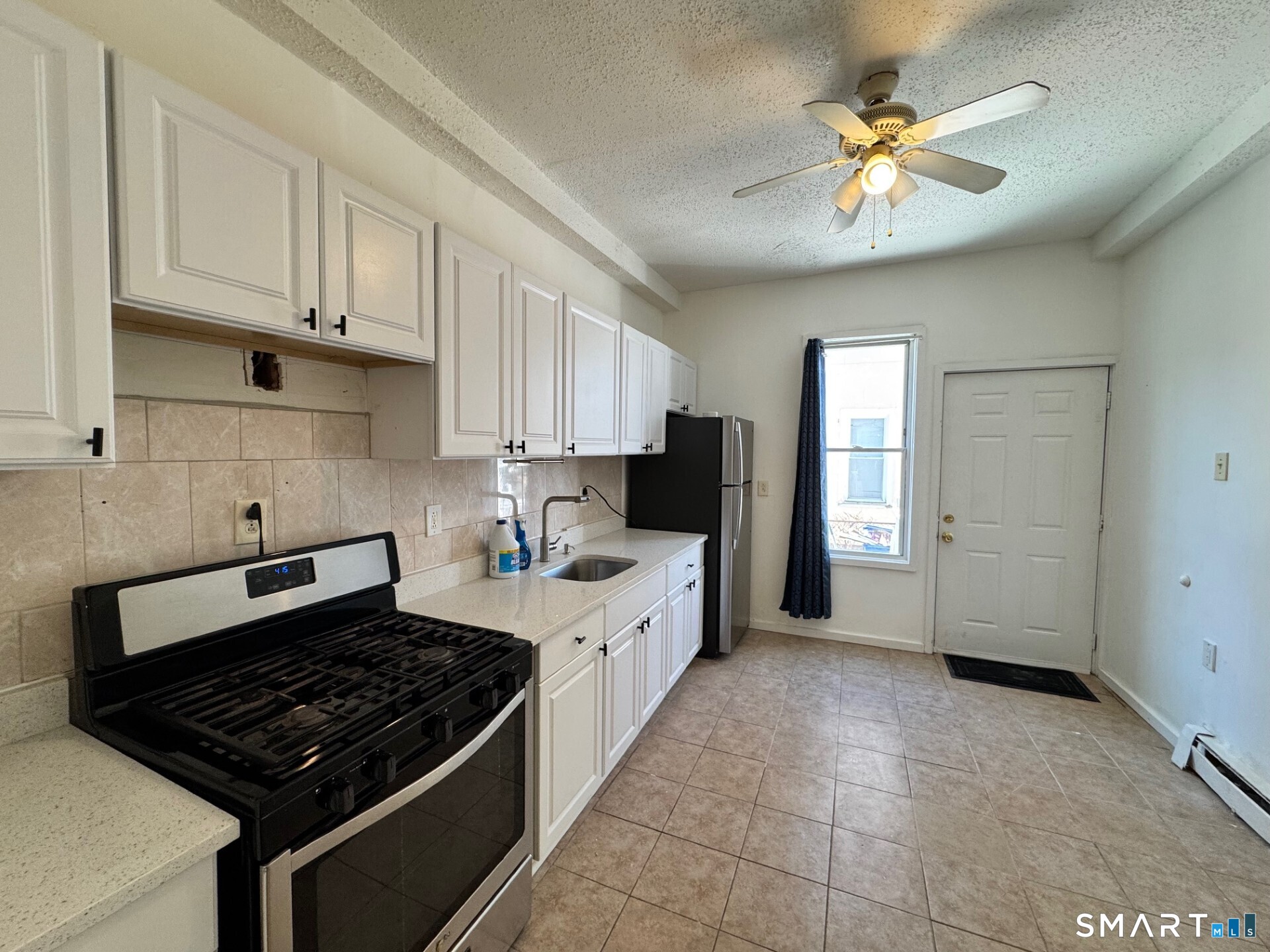 1 Seeley Street, Unit 2 Bridgeport, CT 06605 - Photo 8 of 8 a kitchen with a stove a sink and cabinets