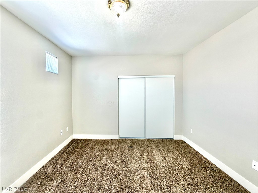 8555 West Russell Road, Unit 2018 Las Vegas, NV 89113 - Photo 22 of 23 A well-proportioned room with warm-toned carpeting and ample closet space awaits customization.