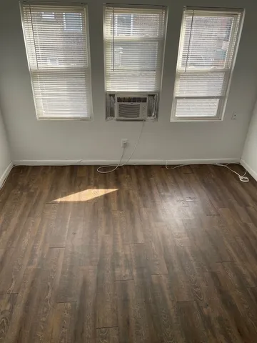 a view of a room with wooden floor and windows