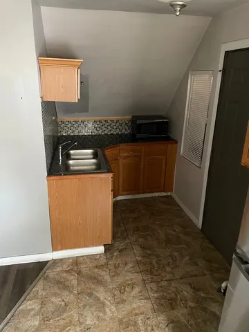 a kitchen with a refrigerator and a stove