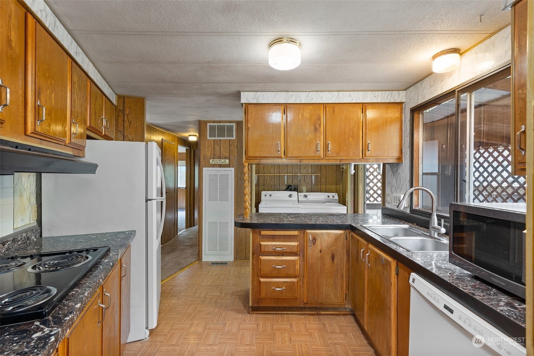 1001 Logan Hill Road Chehalis, WA 98532 - Photo 13 of 23 a kitchen with a stove a sink and a refrigerator