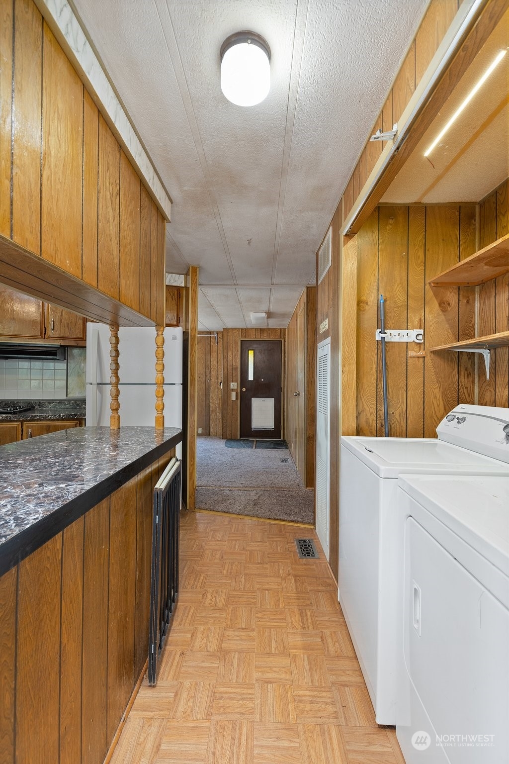 1001 Logan Hill Road Chehalis, WA 98532 - Photo 16 of 23 a view of a kitchen with a sink and dishwasher a kitchen island with wooden cabinets