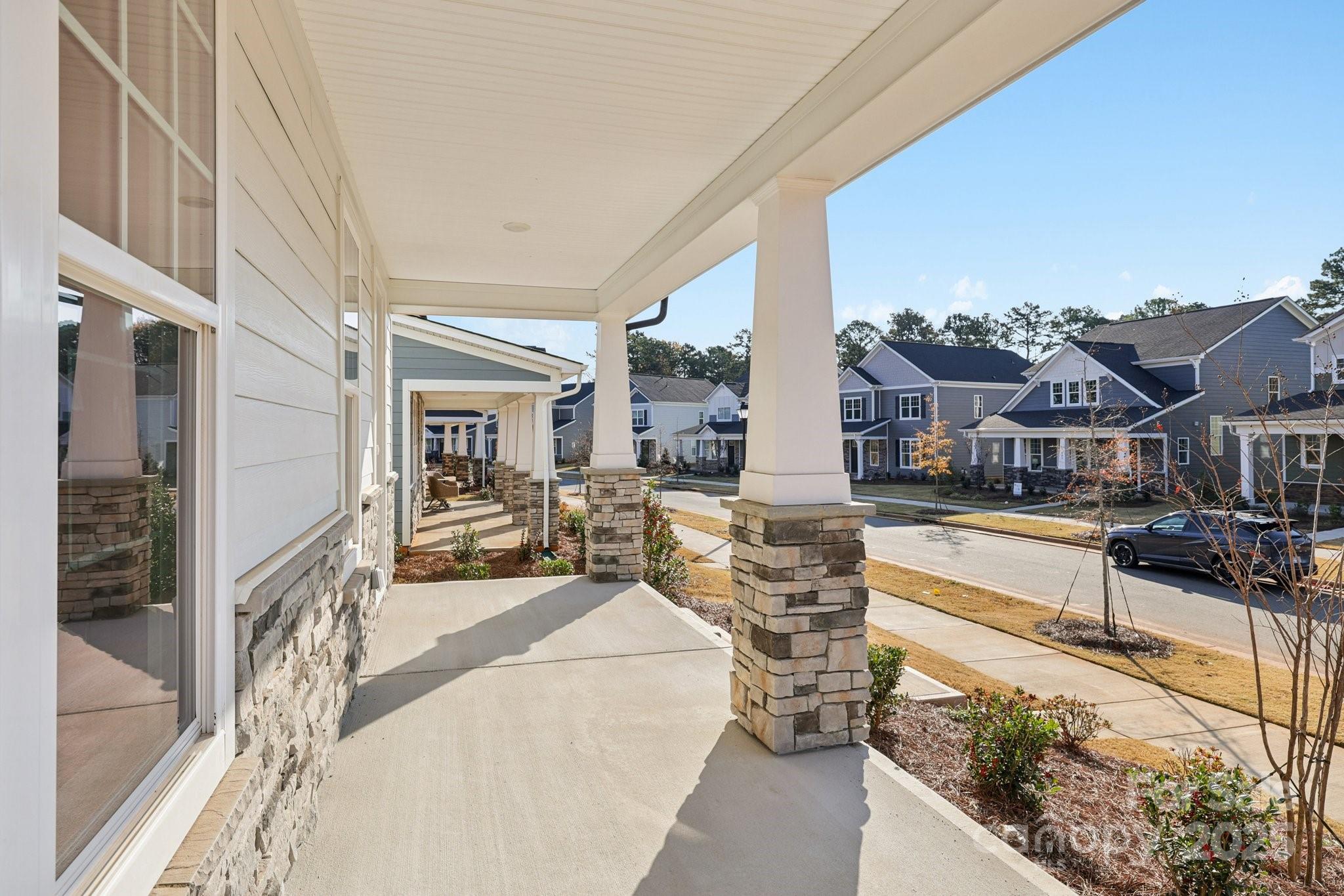 9612 Pointer Road, Unit 59 Huntersville, NC 28078 - Photo 6 of 43 a view of a balcony with couches and wooden floor
