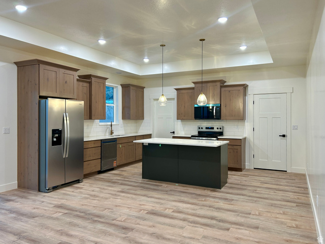 6 South 450th West Gunnison, UT 84634 - Photo 8 of 45 Kitchen featuring wood-finish flooring, recessed lighting, and a tray ceiling