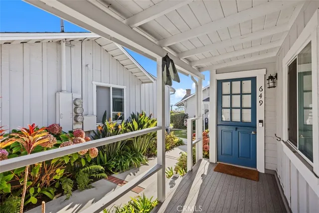 a balcony with beautiful flowers and wooden floor