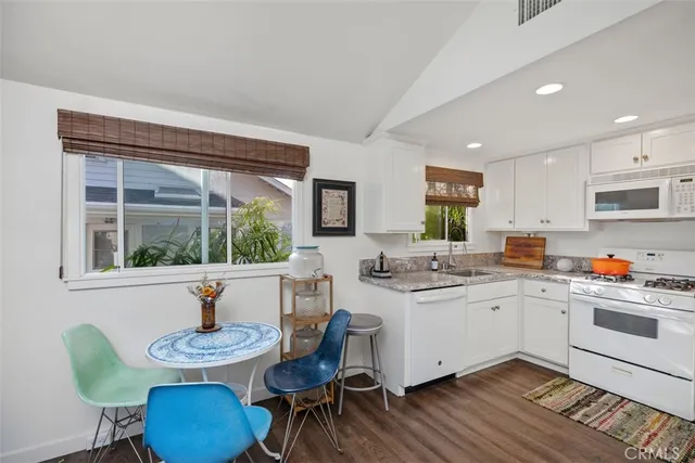 a kitchen with a sink and chairs