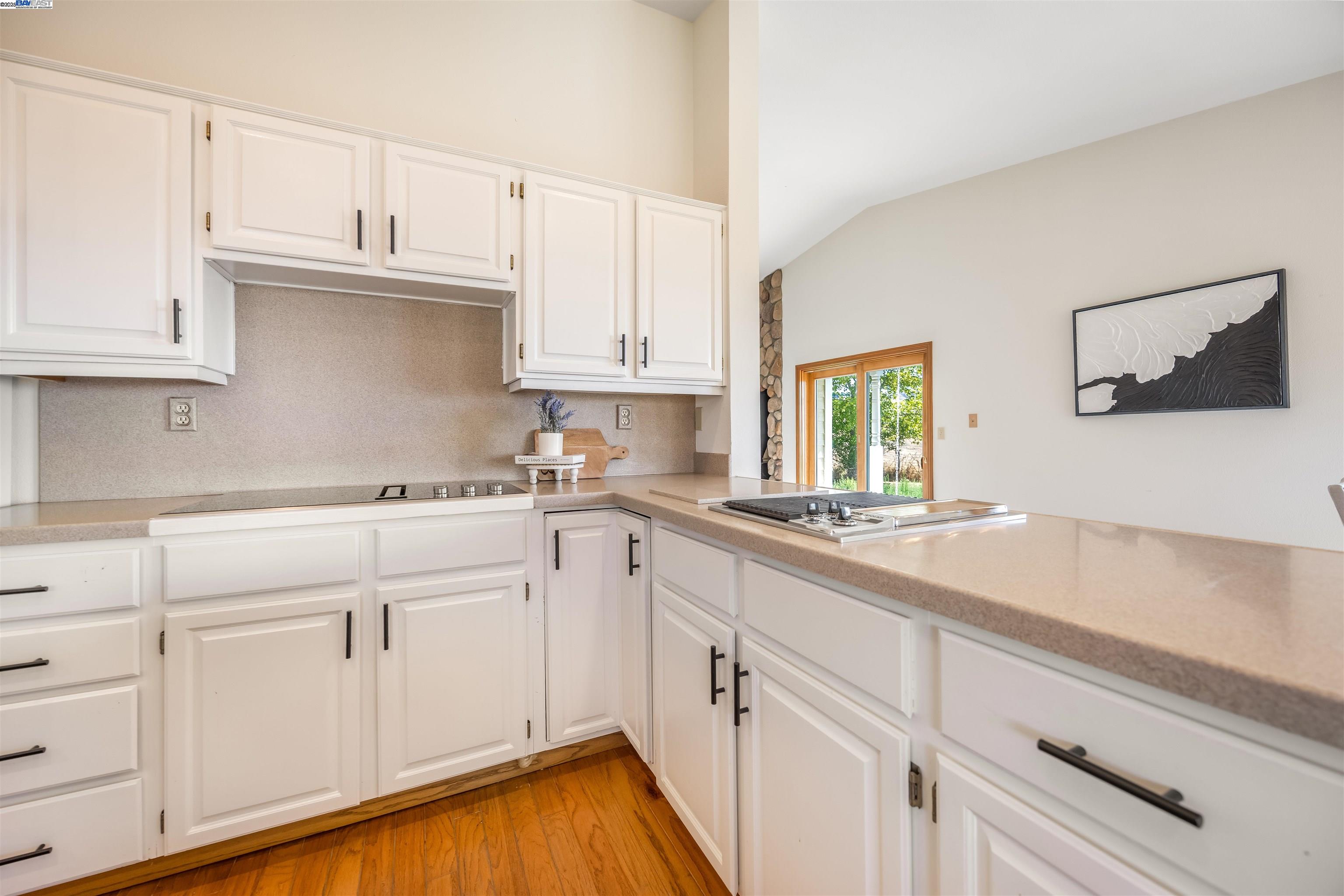 9050 Highland Road Livermore, CA 94551 - Photo 12 of 57 a kitchen with granite countertop white cabinets and white appliances