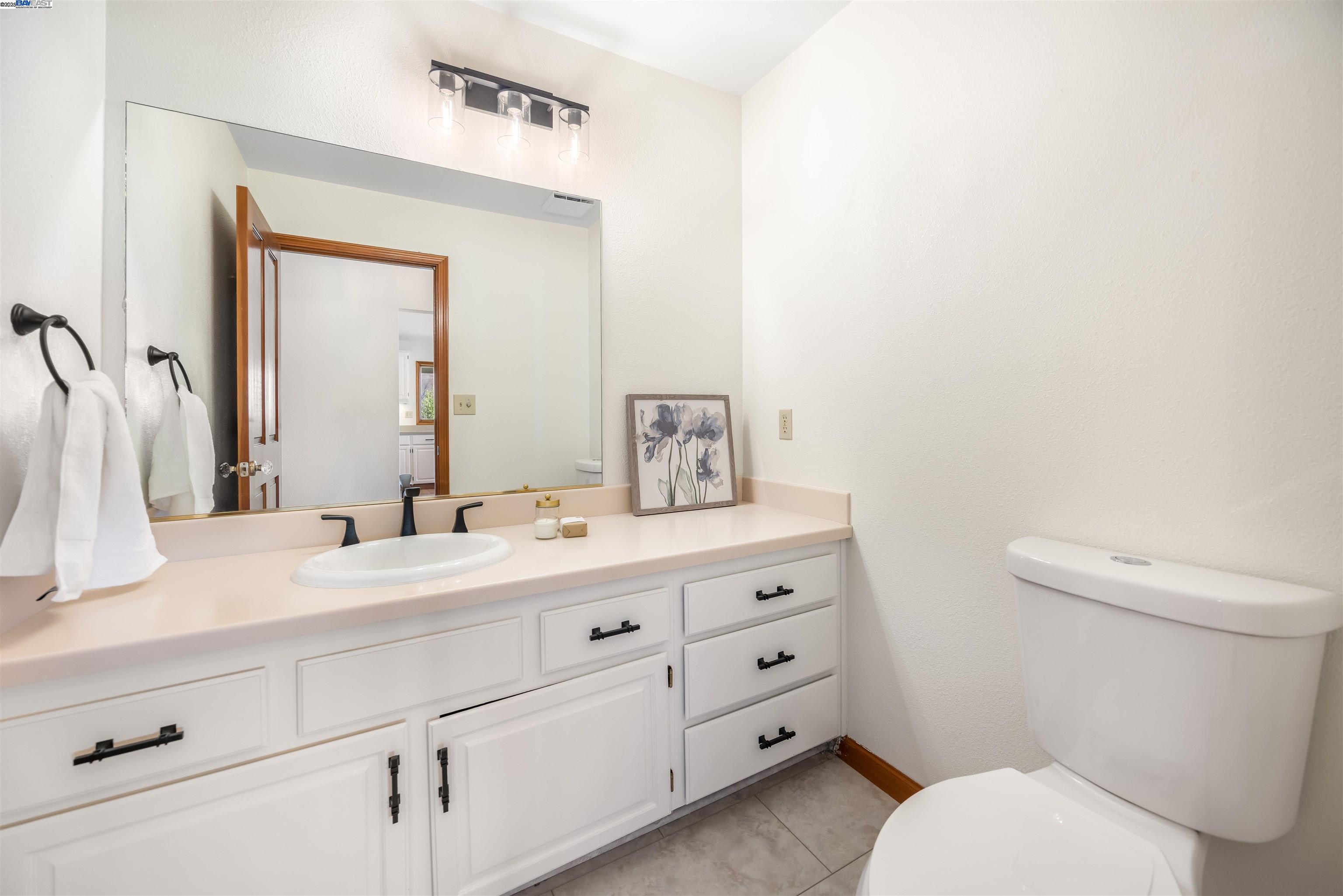 9050 Highland Road Livermore, CA 94551 - Photo 15 of 57 a bathroom with a sink a toilet and mirror