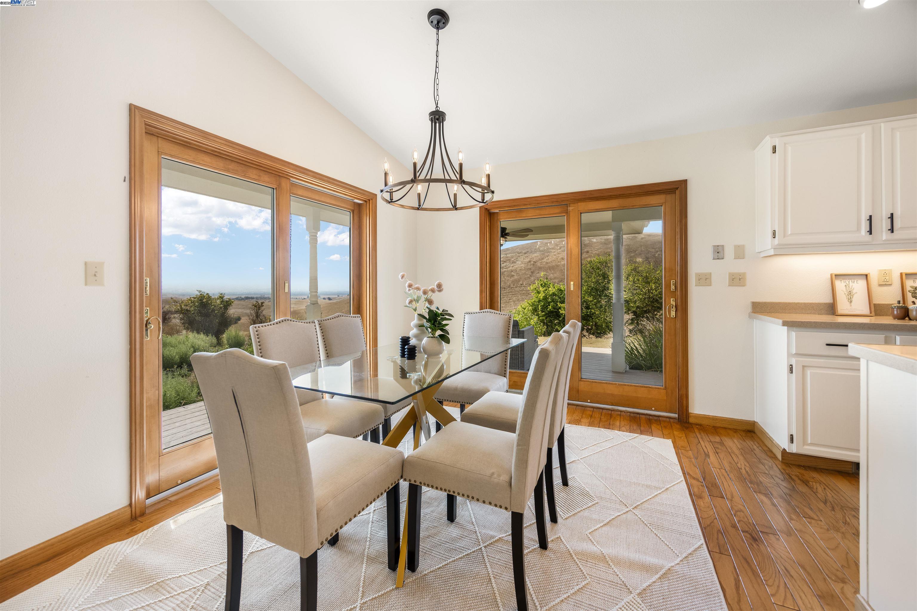9050 Highland Road Livermore, CA 94551 - Photo 19 of 57 a dining room with furniture a chandelier and wooden floor