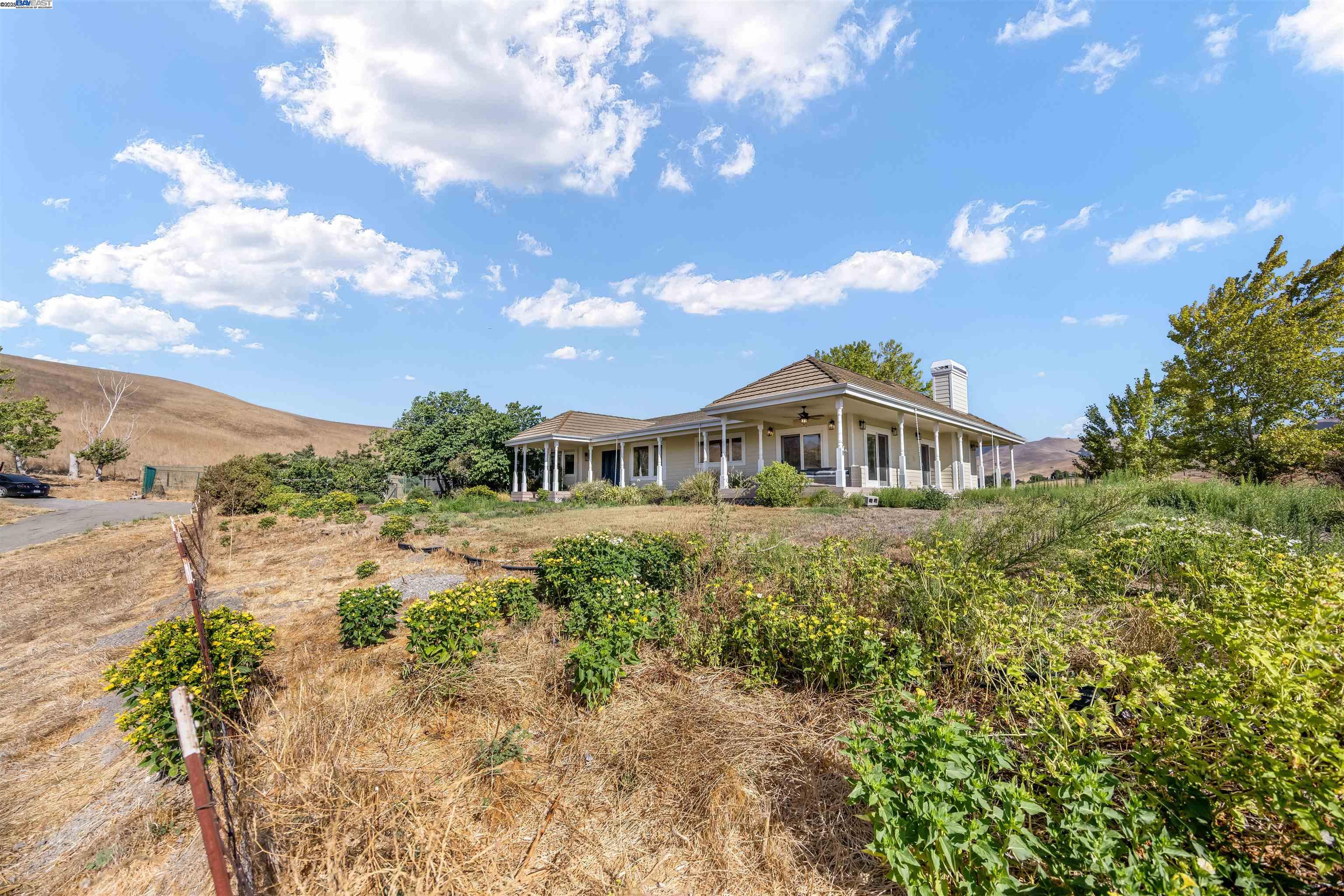 9050 Highland Road Livermore, CA 94551 - Photo 47 of 57 a front view of a house with a yard and mountain view in back