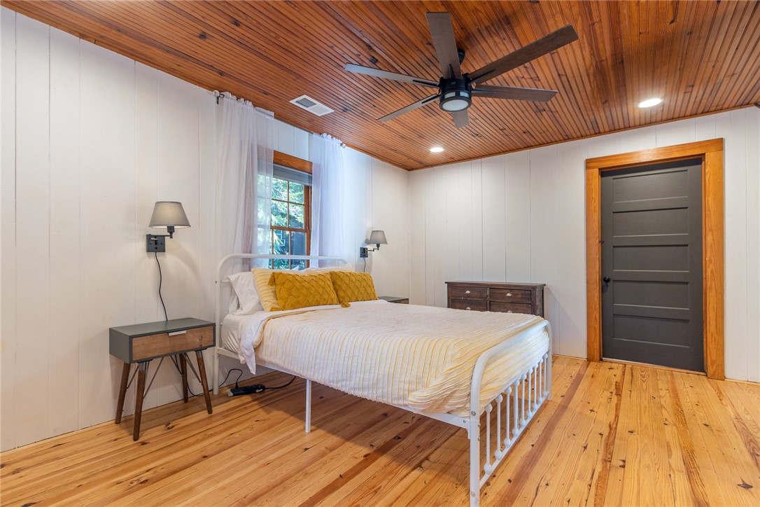 205 Rocky Bottom Road Sunset, SC 29685 - Photo 23 of 46 Rich wood plank ceilings and matching hardwood floors bring warmth to this comfortable bedroom space.