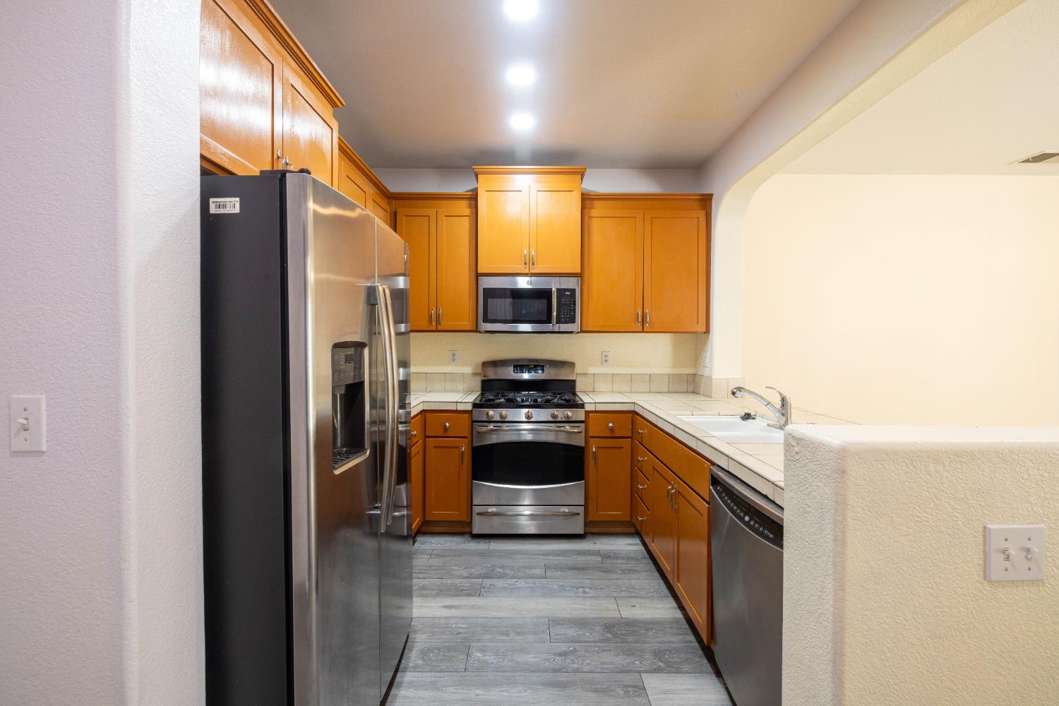 3122 Lea Sterling Way Rancho Cordova, CA 95670 - Photo 7 of 31 a kitchen with stainless steel appliances granite countertop a stove and a refrigerator