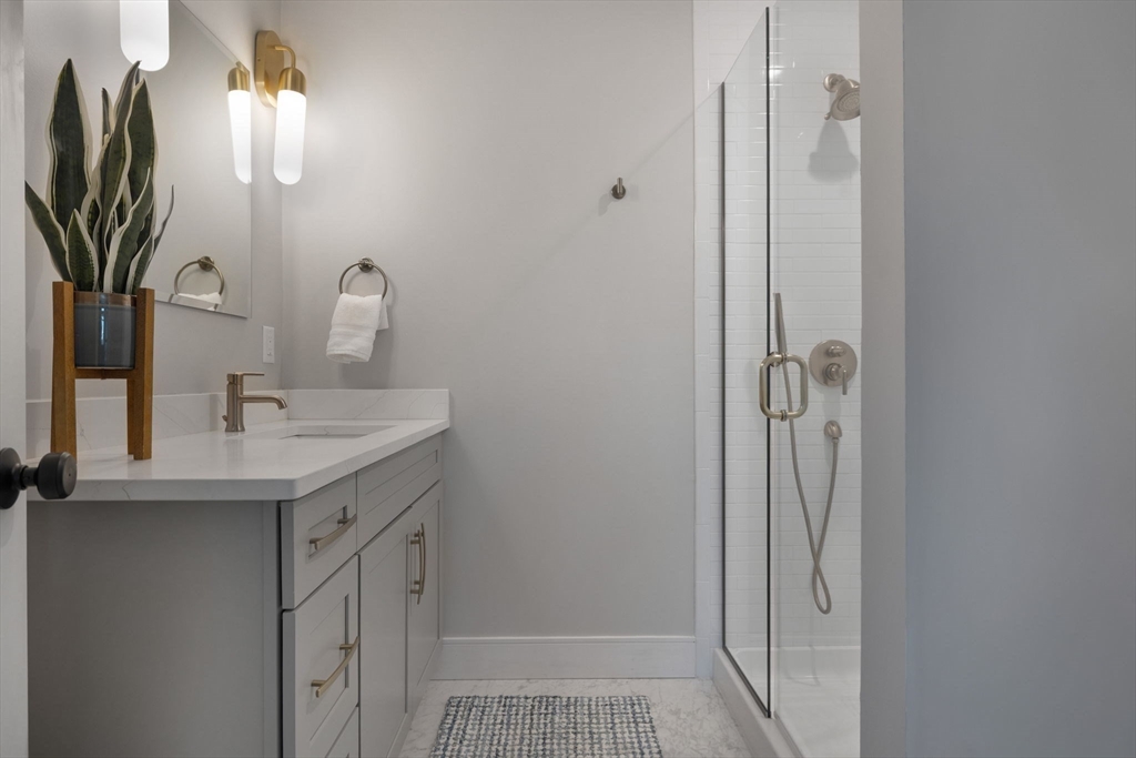 35 East Street Middleton, MA 01949 - Photo 28 of 42 a bathroom with a sink a mirror and shower