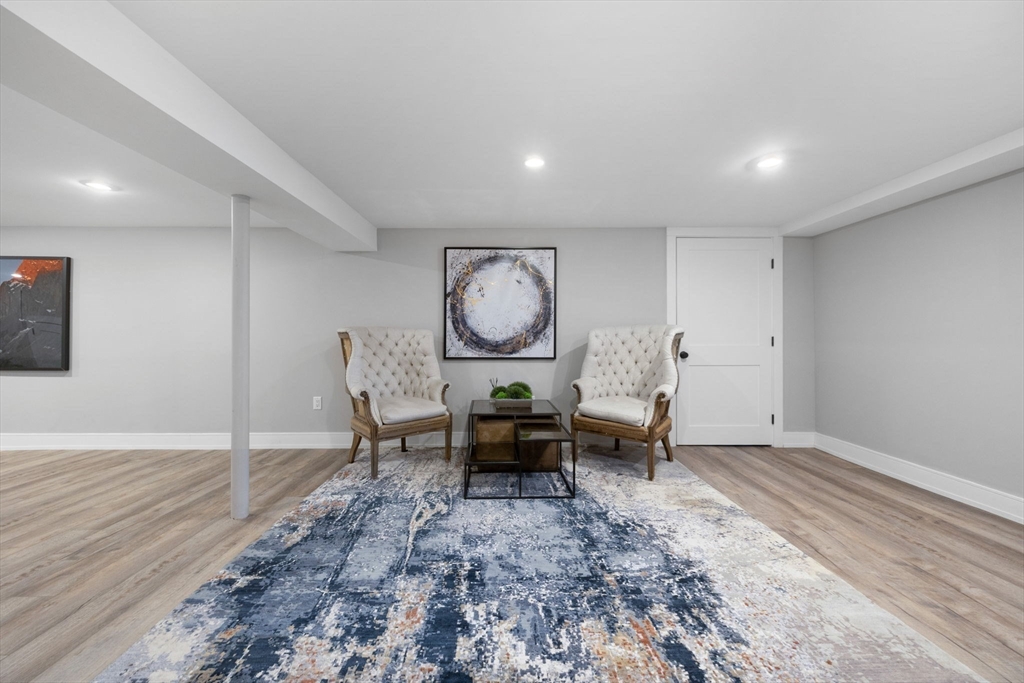 35 East Street Middleton, MA 01949 - Photo 29 of 42 wooden floor in a hall with a dining table and chairs