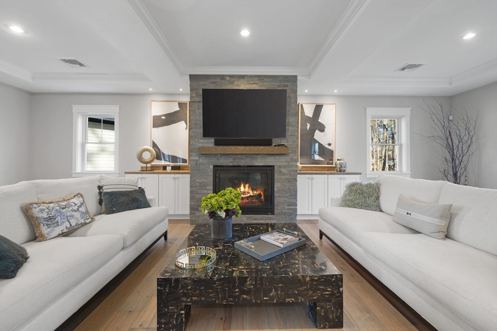35 East Street Middleton, MA 01949 - Photo 5 of 42 a living room with furniture a flat screen tv and a fireplace