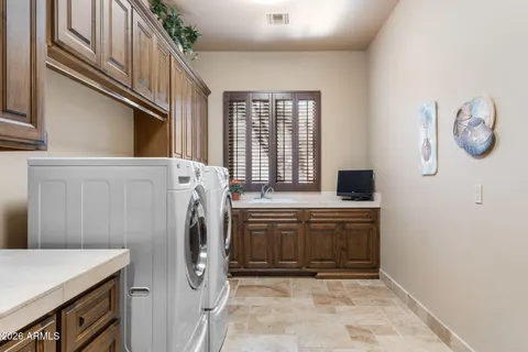 a bathroom with a sink a toilet a tub and shower