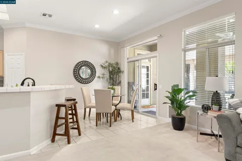 a kitchen with stainless steel appliances white cabinets and a stove a refrigerator with white cabinets