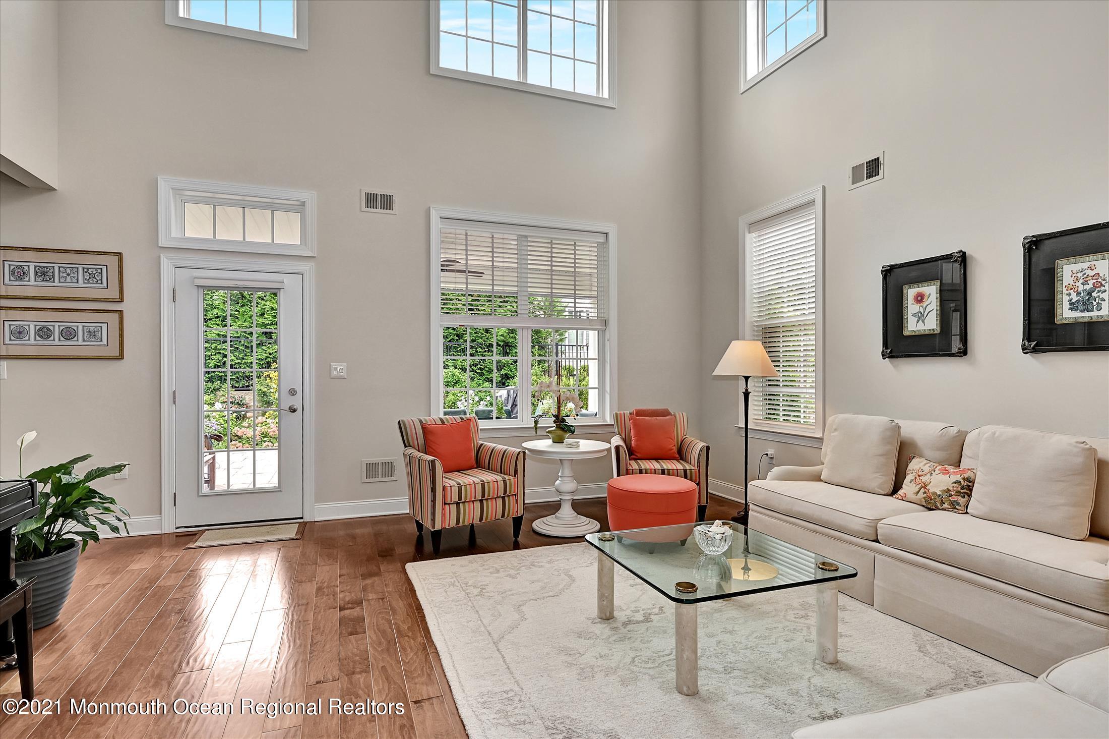 121 Sunset Drive Tinton Falls, NJ 07724 - Photo 14 of 40 a living room with furniture and a large window