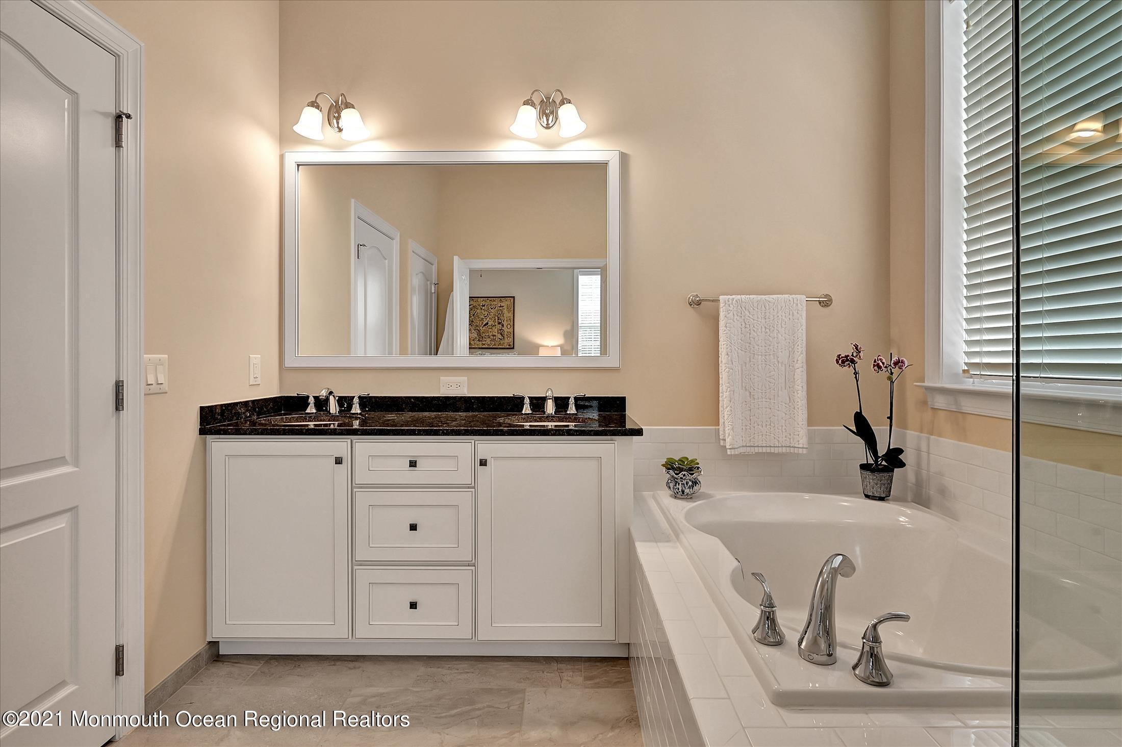 121 Sunset Drive Tinton Falls, NJ 07724 - Photo 17 of 40 a bathroom with a sink and a mirror