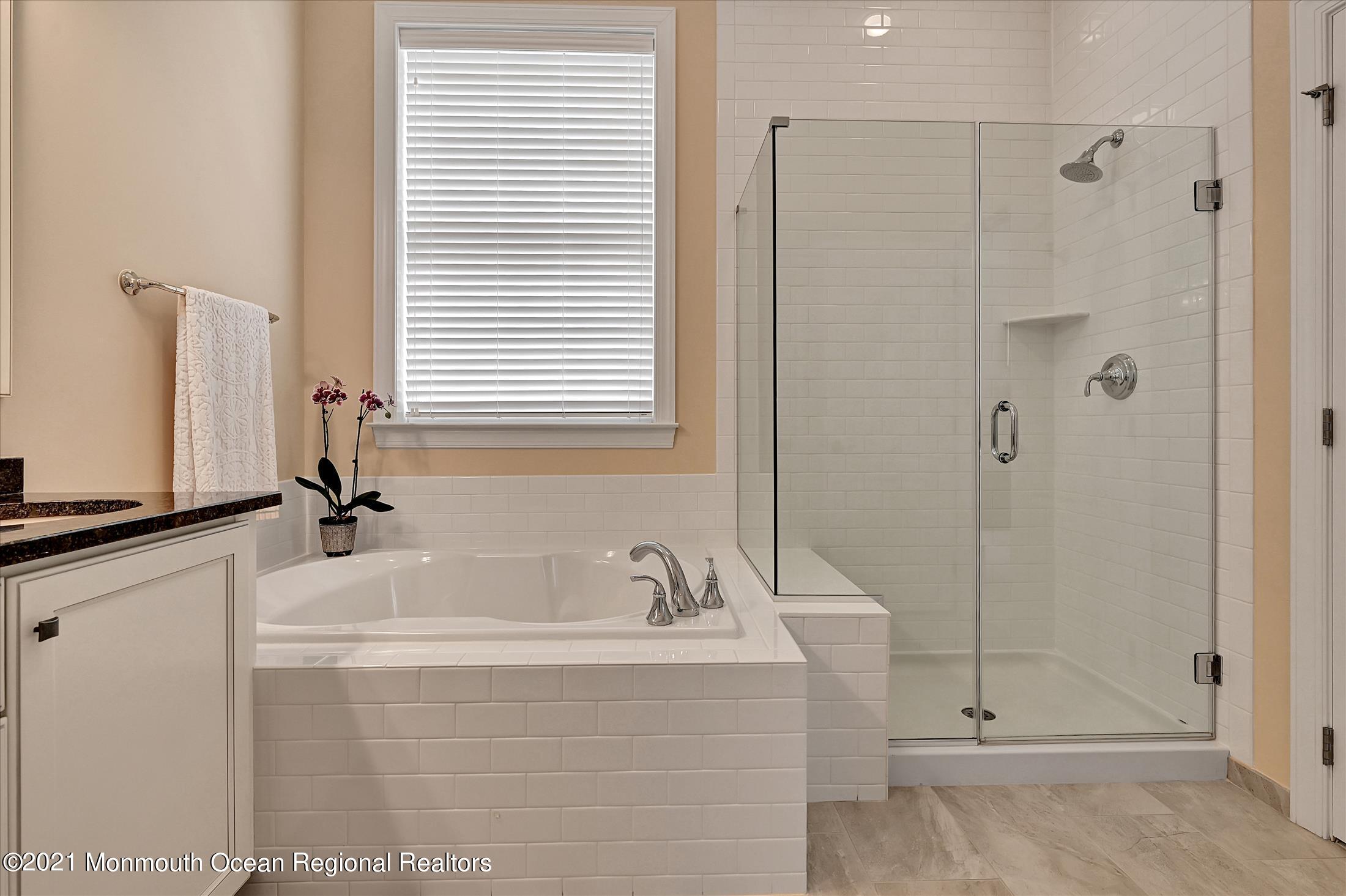 121 Sunset Drive Tinton Falls, NJ 07724 - Photo 18 of 40 a bathroom with a tub sink and mirror