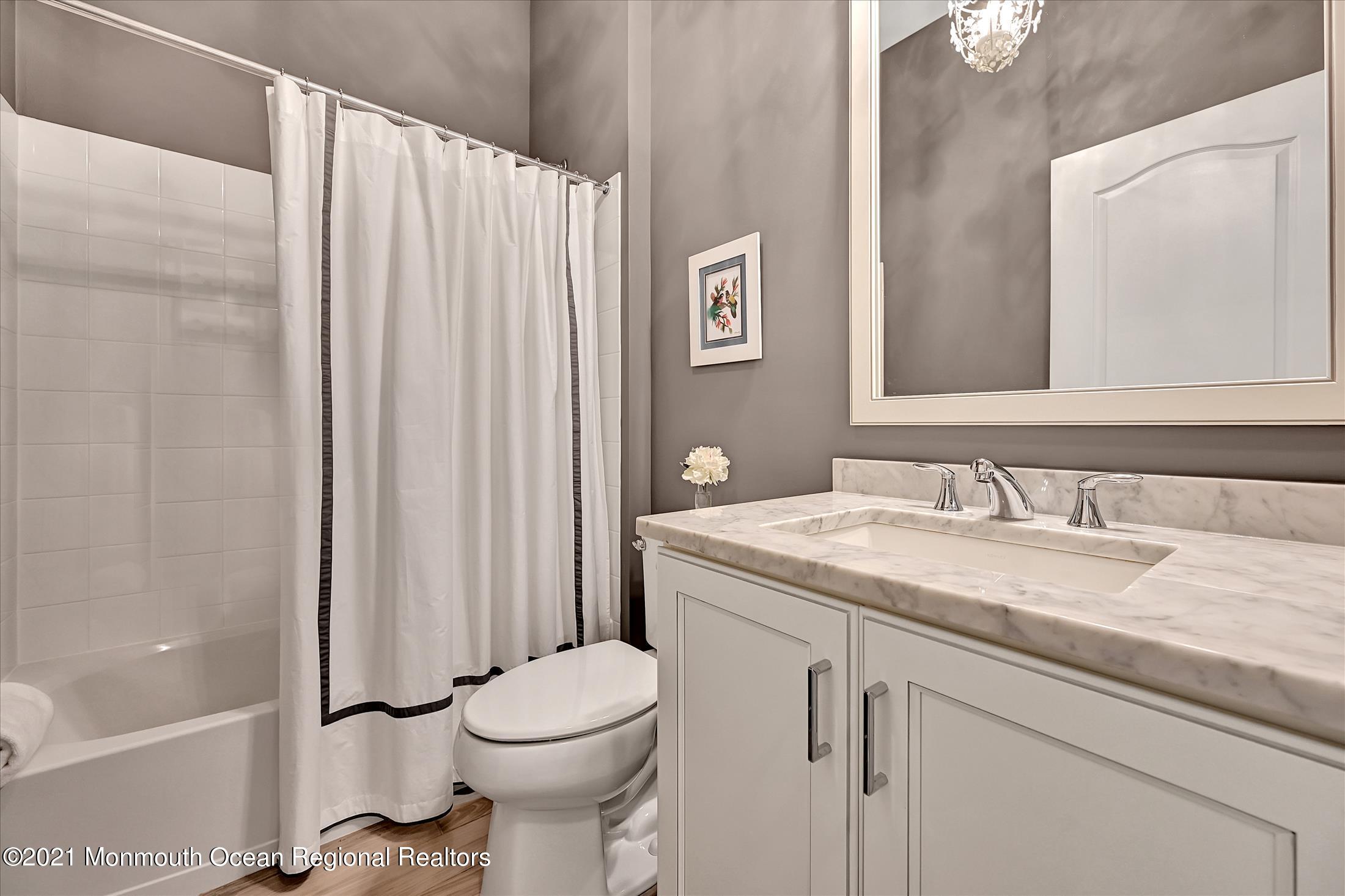 121 Sunset Drive Tinton Falls, NJ 07724 - Photo 21 of 40 a bathroom with a granite countertop sink toilet and shower