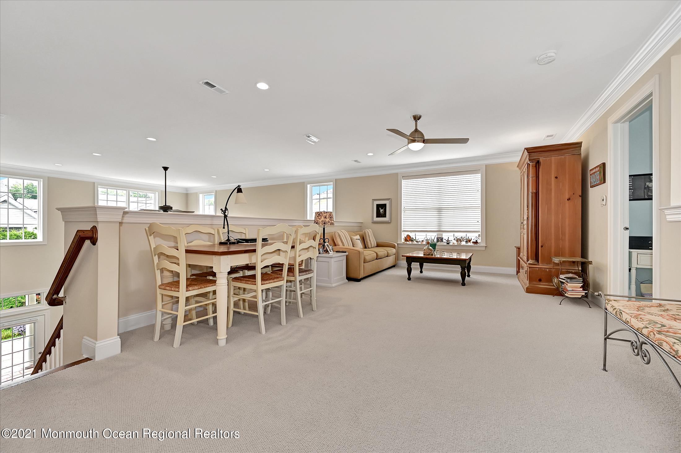 121 Sunset Drive Tinton Falls, NJ 07724 - Photo 24 of 40 a living room with lots of furniture and a chandelier