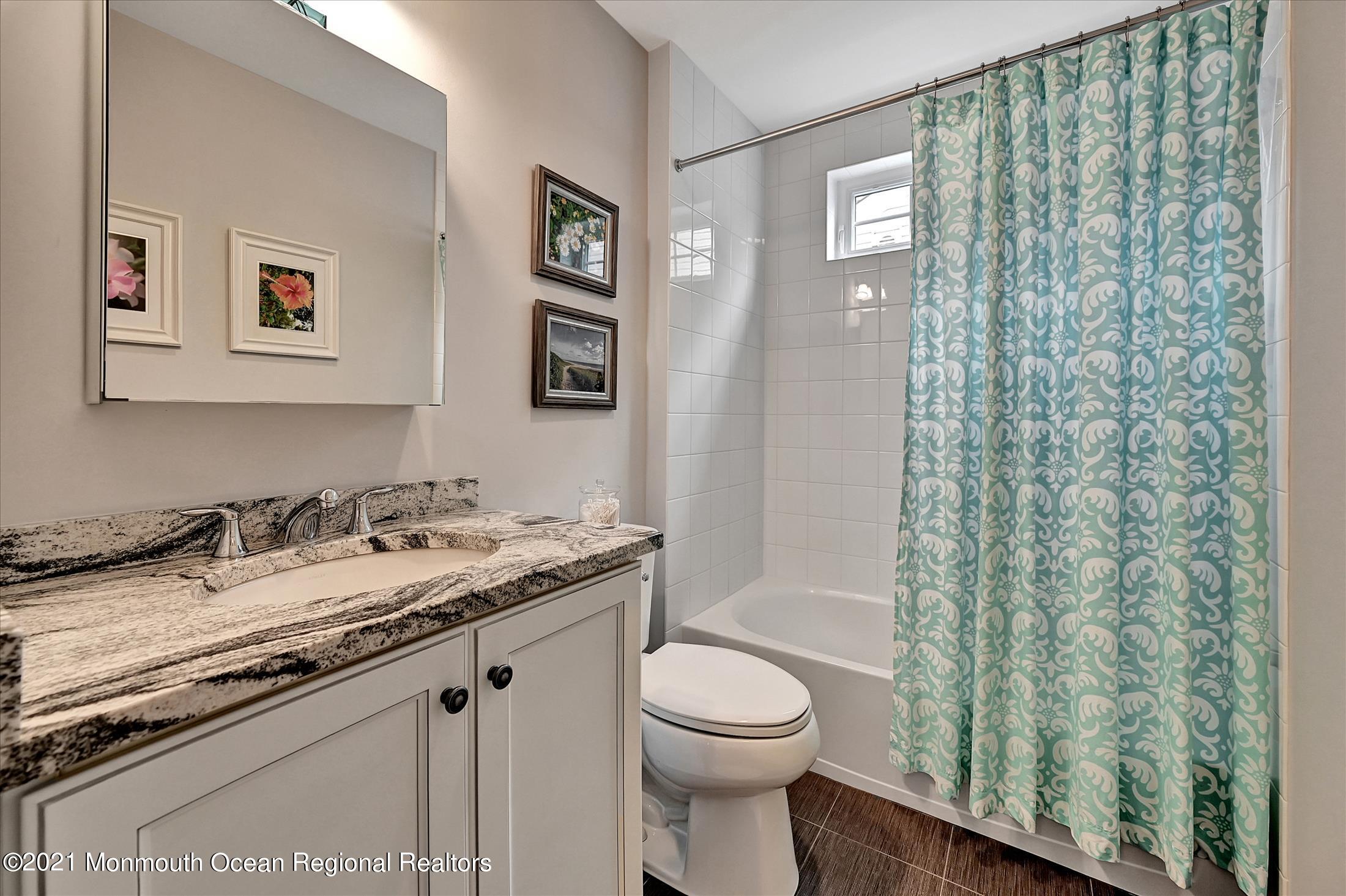 121 Sunset Drive Tinton Falls, NJ 07724 - Photo 26 of 40 a bathroom with a granite countertop sink toilet and shower