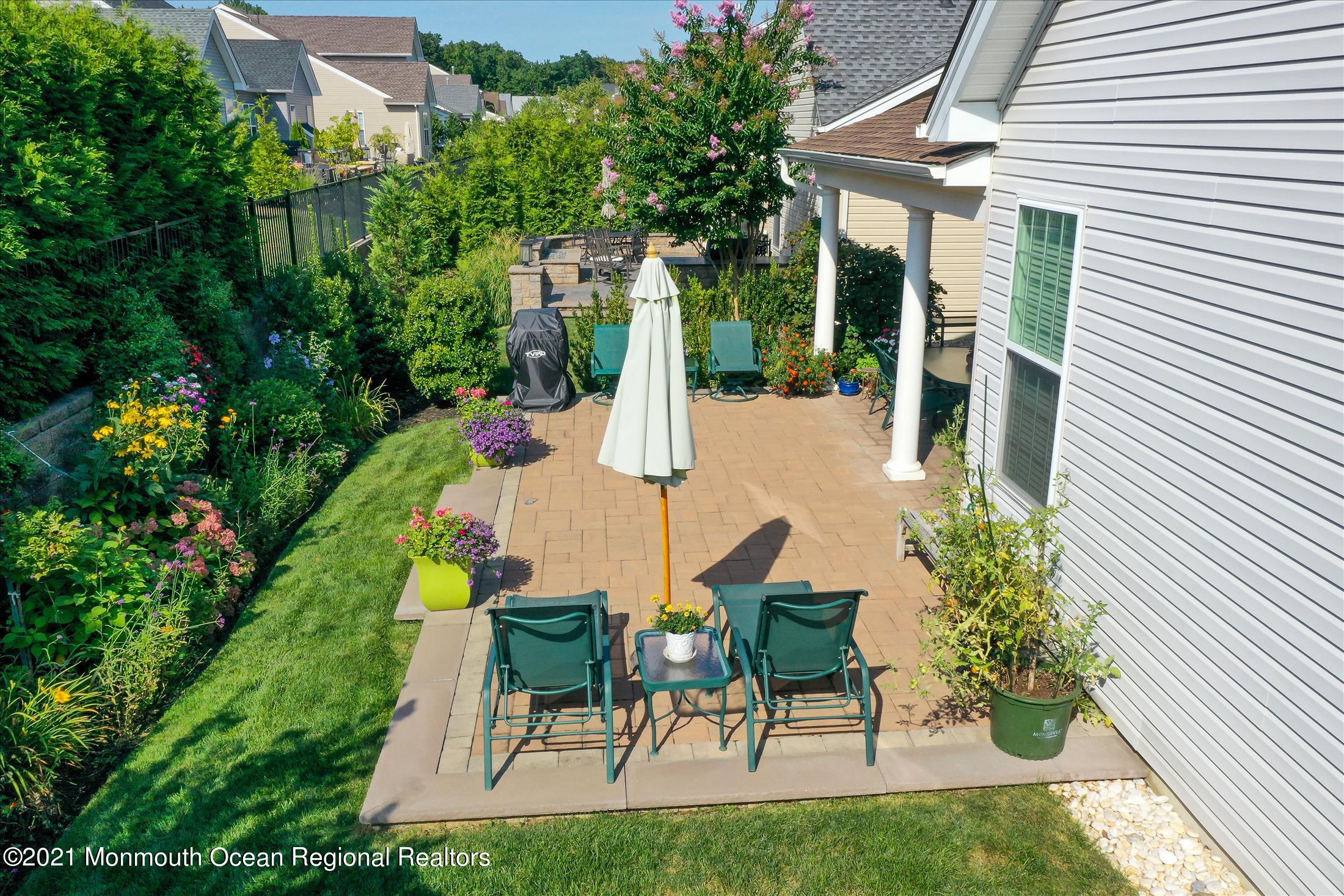 121 Sunset Drive Tinton Falls, NJ 07724 - Photo 27 of 40 a view of an chairs and table in backyard