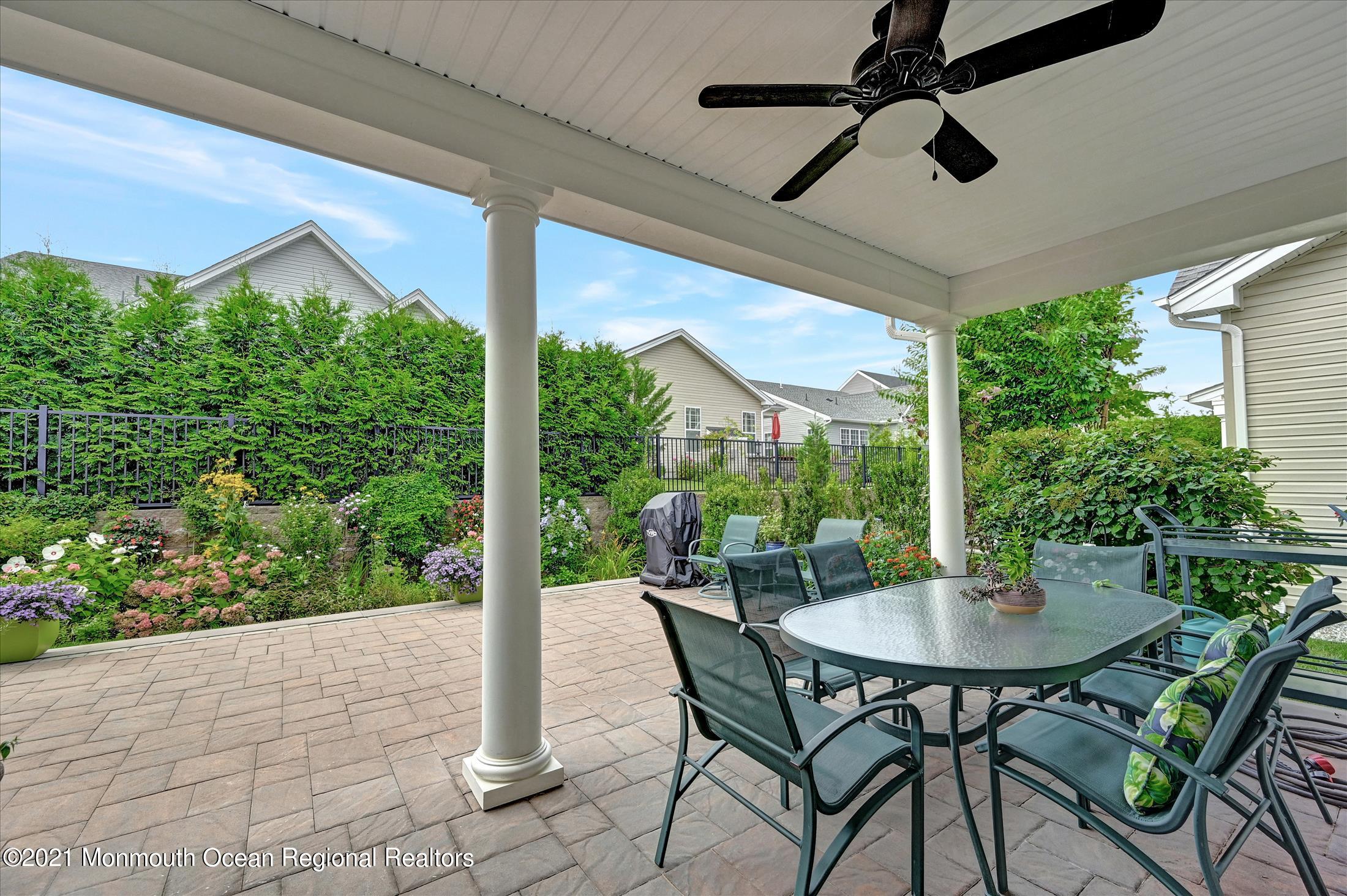 121 Sunset Drive Tinton Falls, NJ 07724 - Photo 28 of 40 a view of an outdoor dining space with a table and chairs