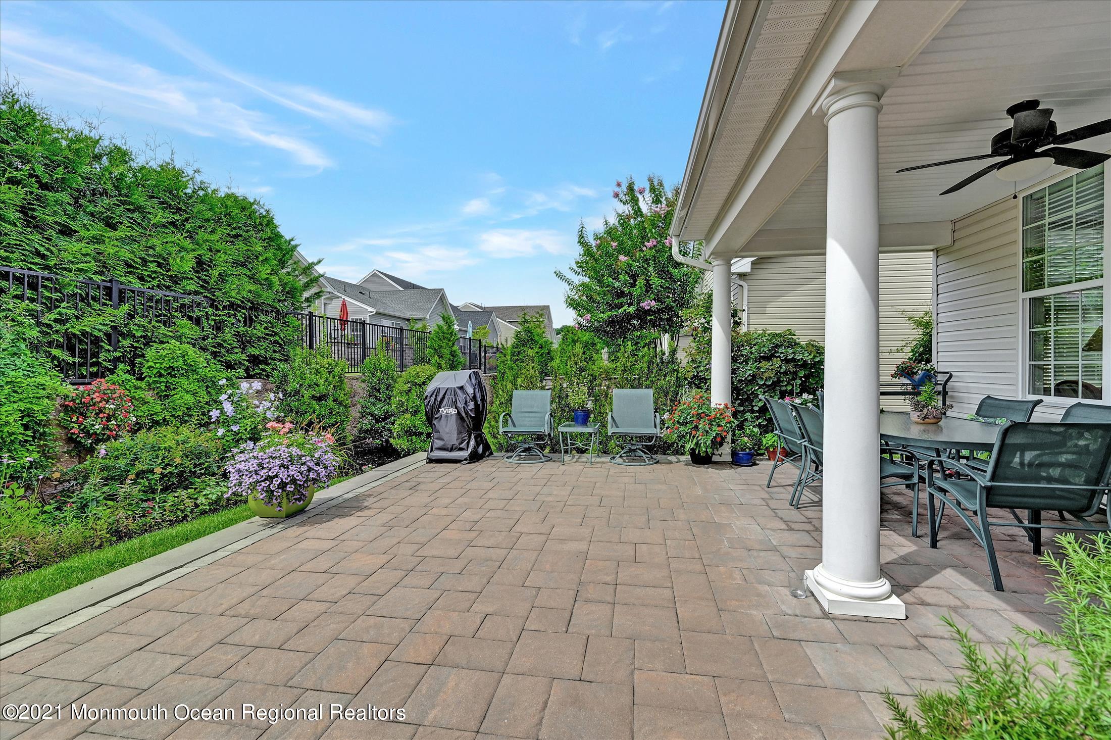 121 Sunset Drive Tinton Falls, NJ 07724 - Photo 30 of 40 a view of a patio with table and chairs and potted plants