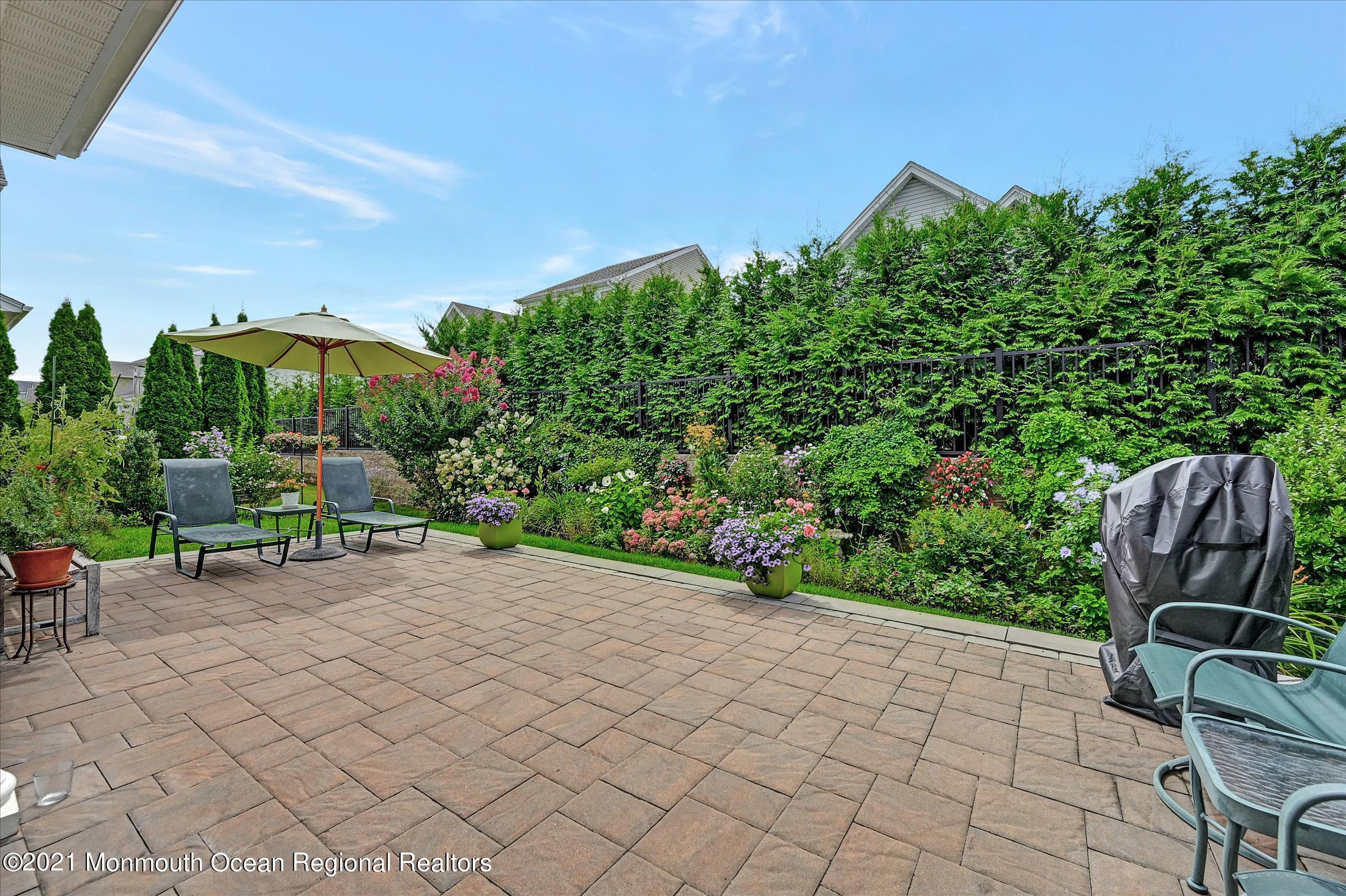121 Sunset Drive Tinton Falls, NJ 07724 - Photo 31 of 40 a view of a chairs and table in a backyard