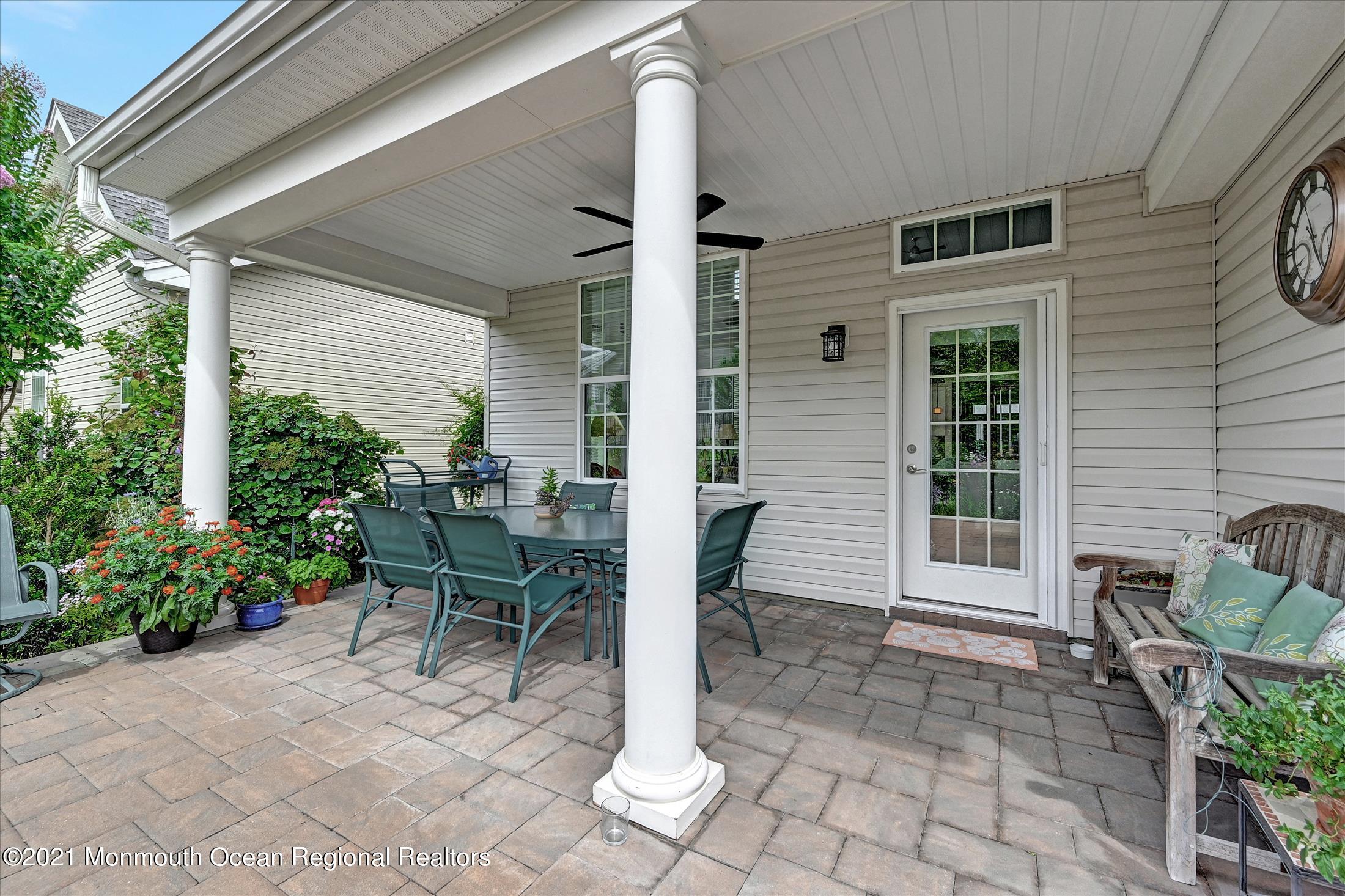 121 Sunset Drive Tinton Falls, NJ 07724 - Photo 32 of 40 a view of a patio with table and chairs and potted plants