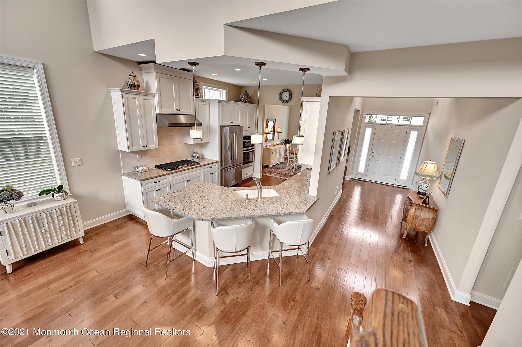 121 Sunset Drive Tinton Falls, NJ 07724 - Photo 6 of 40 a dining room with furniture and wooden floor