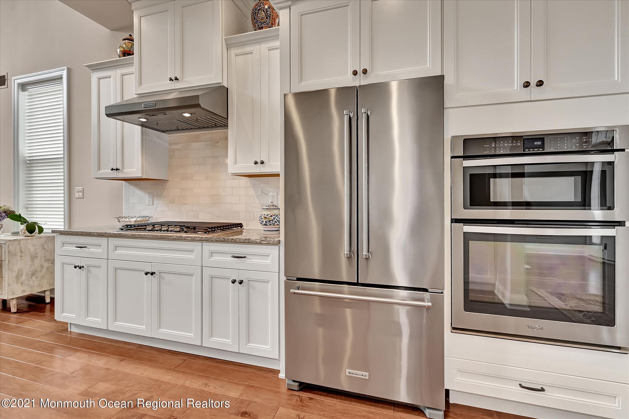 121 Sunset Drive Tinton Falls, NJ 07724 - Photo 9 of 40 a kitchen with stainless steel appliances white cabinets and a refrigerator
