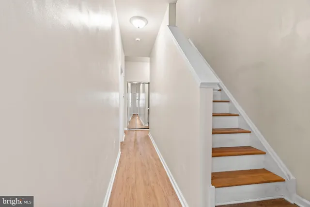 a view of a room with wooden floor and staircase