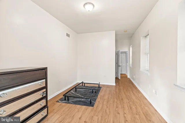a view of walk in closet with empty racks