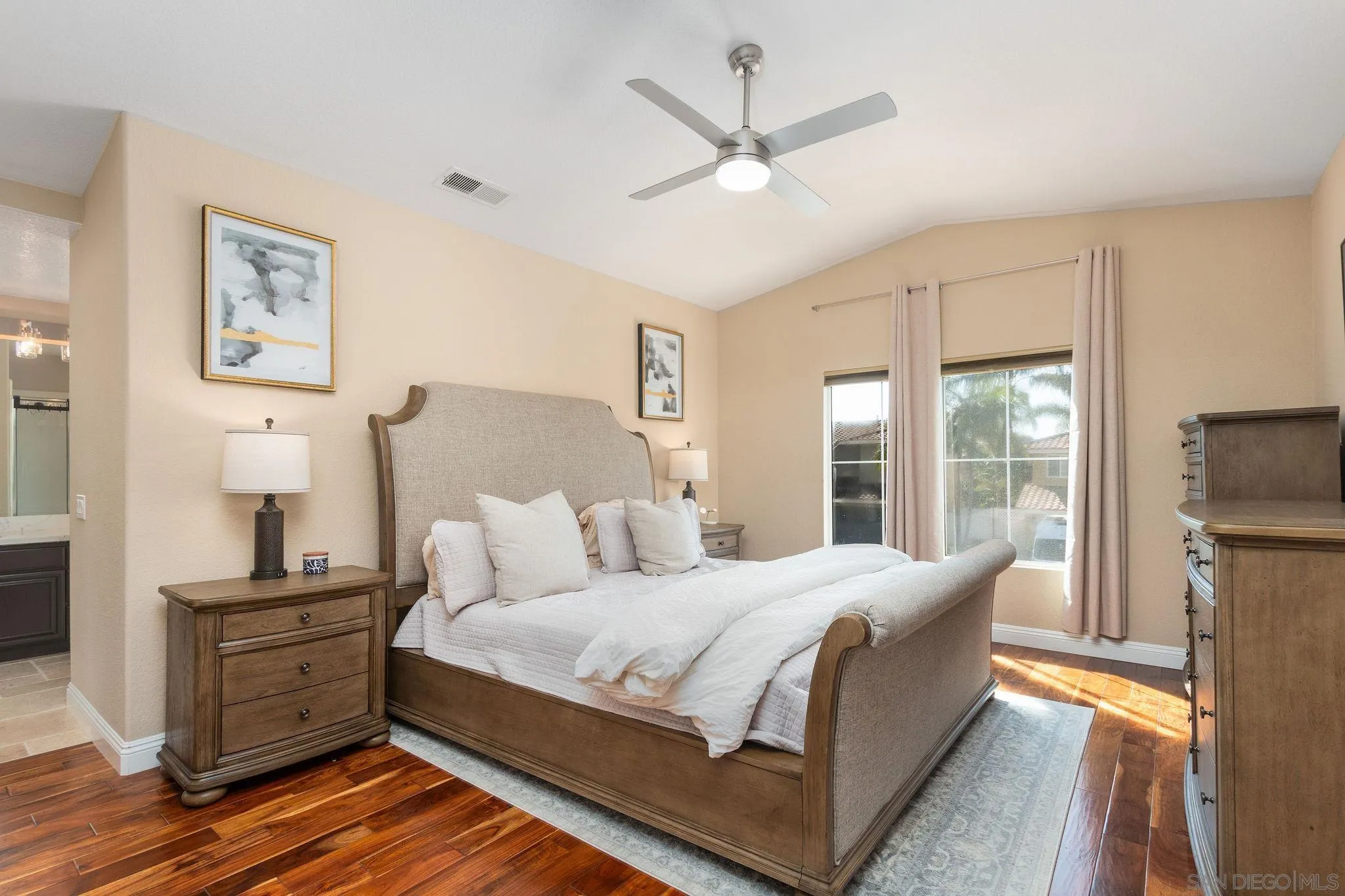 4532 Avenida Privado Oceanside, CA 92057 - Photo 20 of 40 a bedroom with a large bed a flat tv screen and a dresser